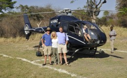 Zambia and Malawi combined - left to right Charlie, Tracy and Francis by a helicopter