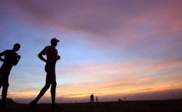 runners running in an African marathon at sunset