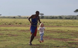 Masai children safari guide educating and entertaining Forbes family children on holiday in the Masai Mara Kenya