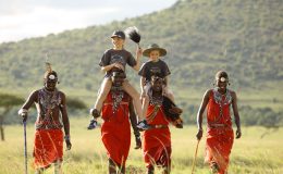 Travelling with children, children on heads and shoulders of Masai, Masai Mara, Kenya AndBeyond Kichwa Tembo