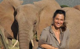 Conservationist and guide Saba Douglas-Hamilton with an African elephant behind