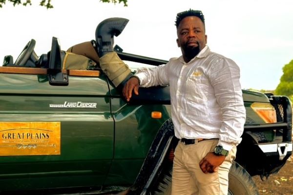 Guide at Tembo Plains poses next to his safari vehicle