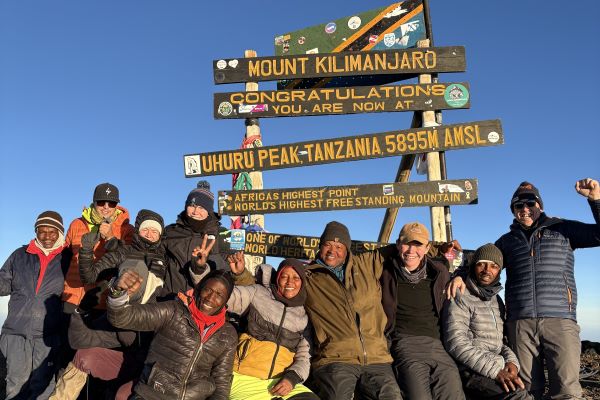 Family and team summit photograph Mount Kilimanjaro, Tanzania